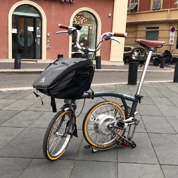 Driiven electric Brompton — a precision-engineered, limited-production urban mobility object featuring a wireless electric drive system with energy recovery, inspired by advanced KERS technology, integrated within a compact folding frame.